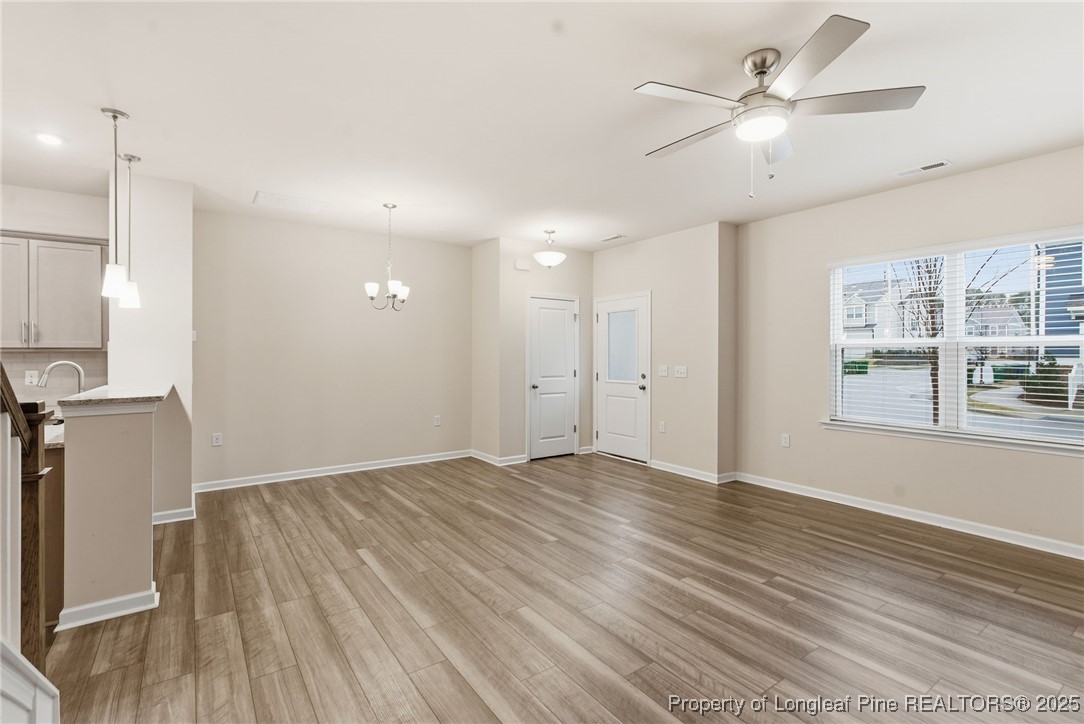 245 Ribbon Rail Street Fuquay-Varina, NC 27526 - Photo 12 of 43 a view of an empty room with a window and wooden floor