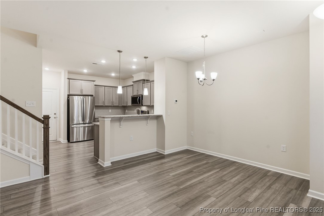 245 Ribbon Rail Street Fuquay-Varina, NC 27526 - Photo 13 of 43 a view of kitchen with granite countertop cabinets and refrigerator