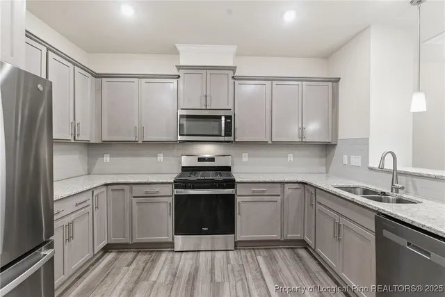 a kitchen with a sink stove and cabinets