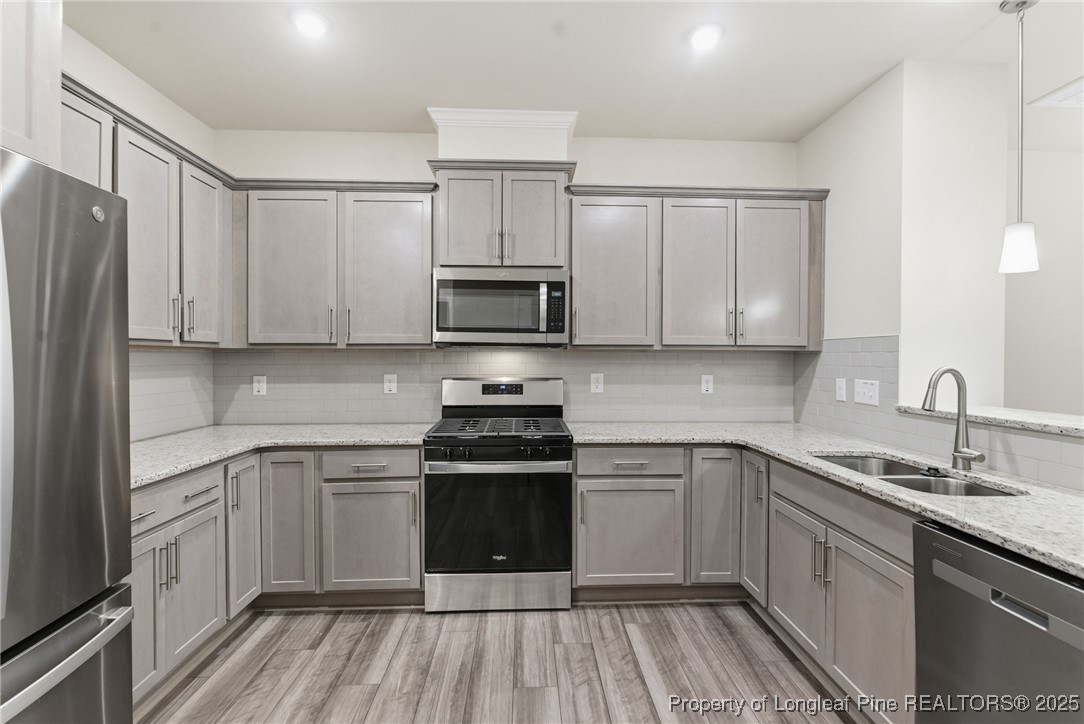 245 Ribbon Rail Street Fuquay-Varina, NC 27526 - Photo 16 of 43 a kitchen with a sink stove and cabinets