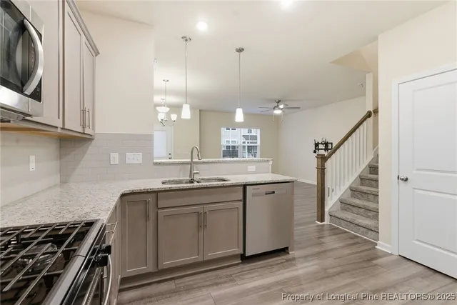 a kitchen with sink stove and cabinets