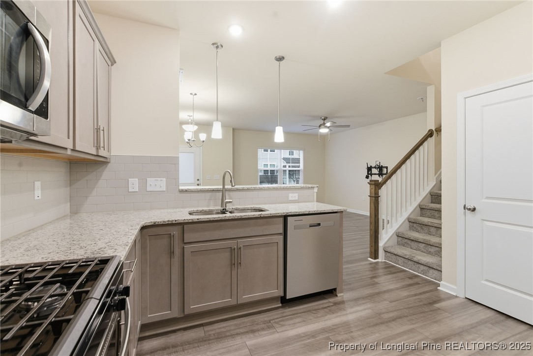 245 Ribbon Rail Street Fuquay-Varina, NC 27526 - Photo 18 of 43 a kitchen with sink stove and cabinets