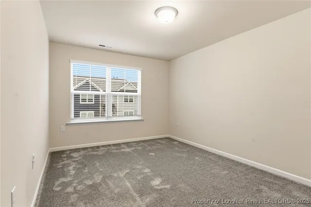 an empty room with closet area