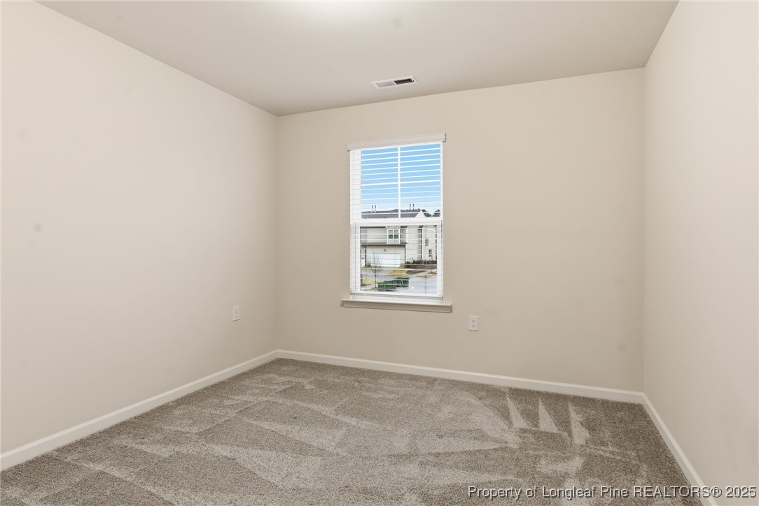 245 Ribbon Rail Street Fuquay-Varina, NC 27526 - Photo 27 of 43 an empty room with a window