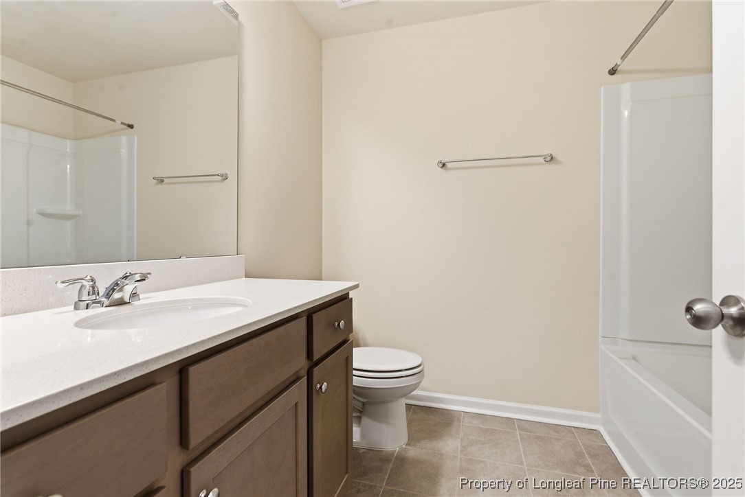 245 Ribbon Rail Street Fuquay-Varina, NC 27526 - Photo 29 of 43 a bathroom with a sink a toilet a shower and a mirror