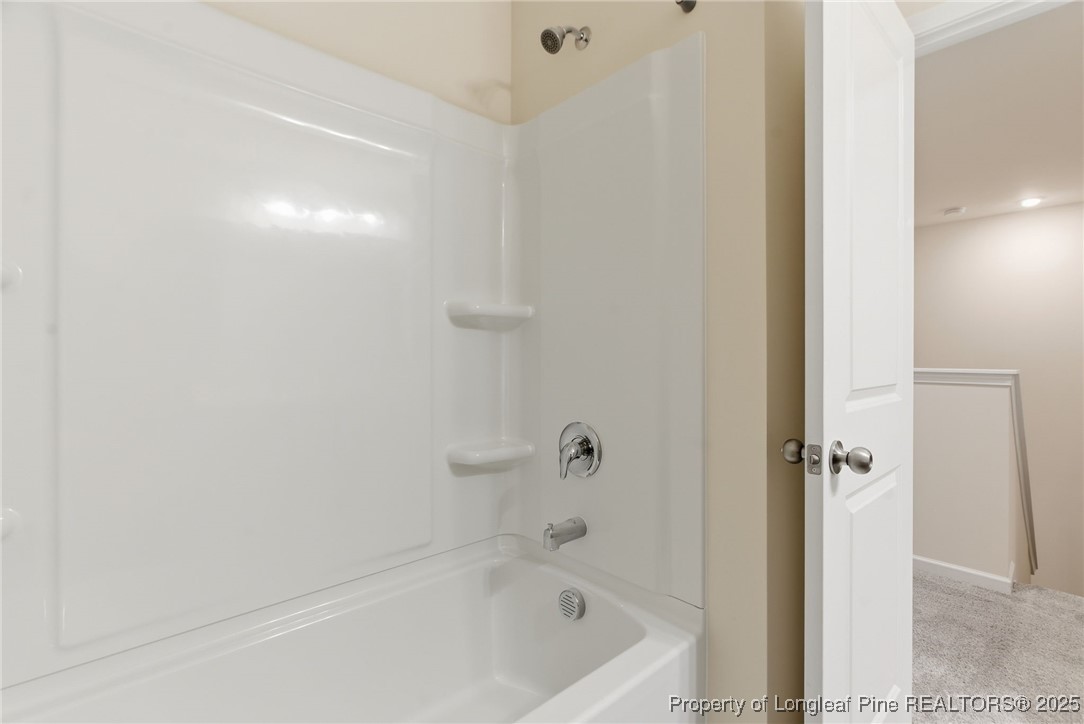 245 Ribbon Rail Street Fuquay-Varina, NC 27526 - Photo 30 of 43 a bathroom with a bathtub