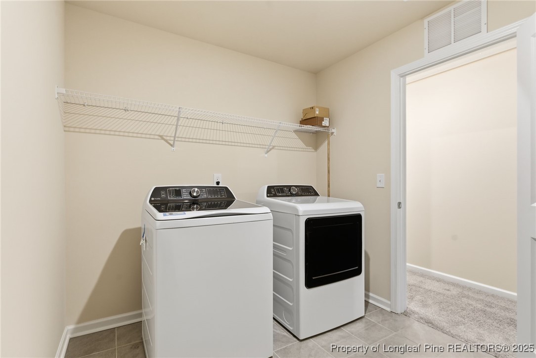 245 Ribbon Rail Street Fuquay-Varina, NC 27526 - Photo 32 of 43 a utility room with dryer and washer