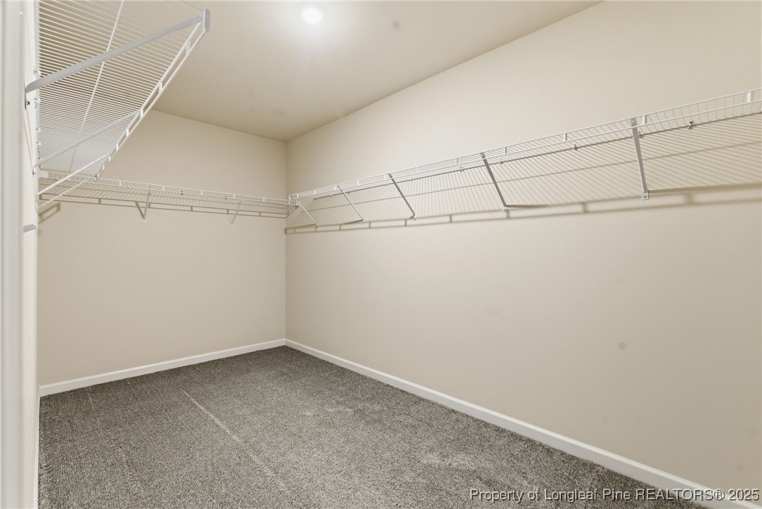 245 Ribbon Rail Street Fuquay-Varina, NC 27526 - Photo 37 of 43 a view of a room with racks on the wall