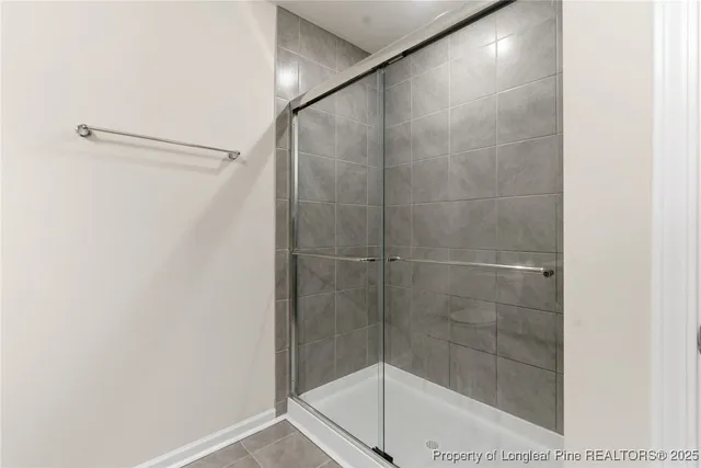 a view of a white building with many windows and palm trees