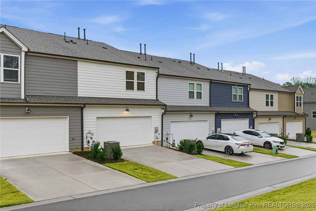 245 Ribbon Rail Street Fuquay-Varina, NC 27526 - Photo 42 of 43 a view of a white building with many windows and palm trees