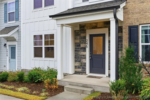 a front view of a house with plants