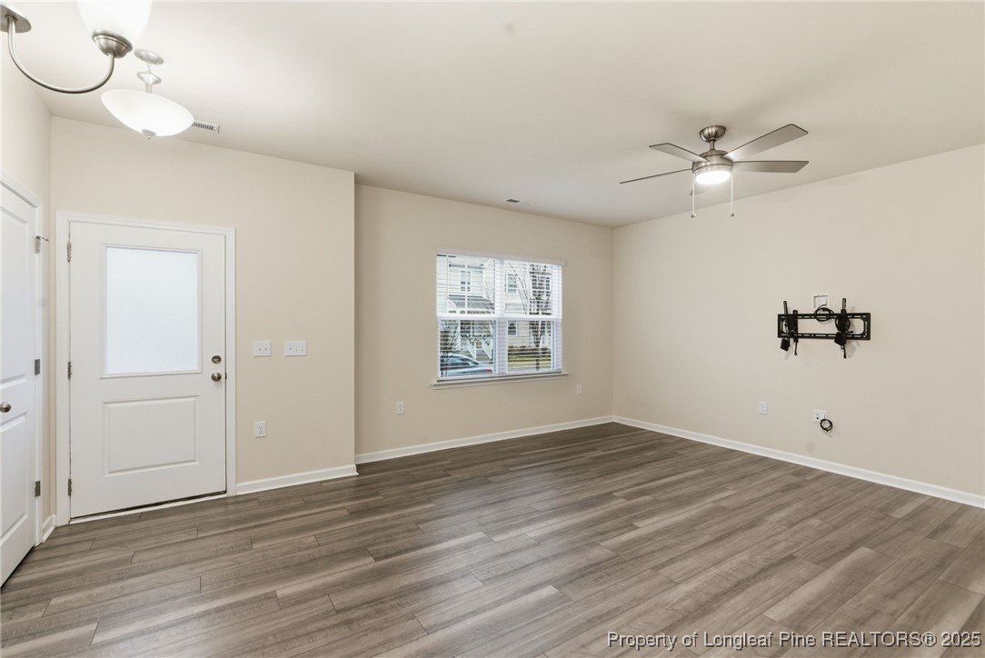 245 Ribbon Rail Street Fuquay-Varina, NC 27526 - Photo 7 of 43 wooden floor in an empty room with a window