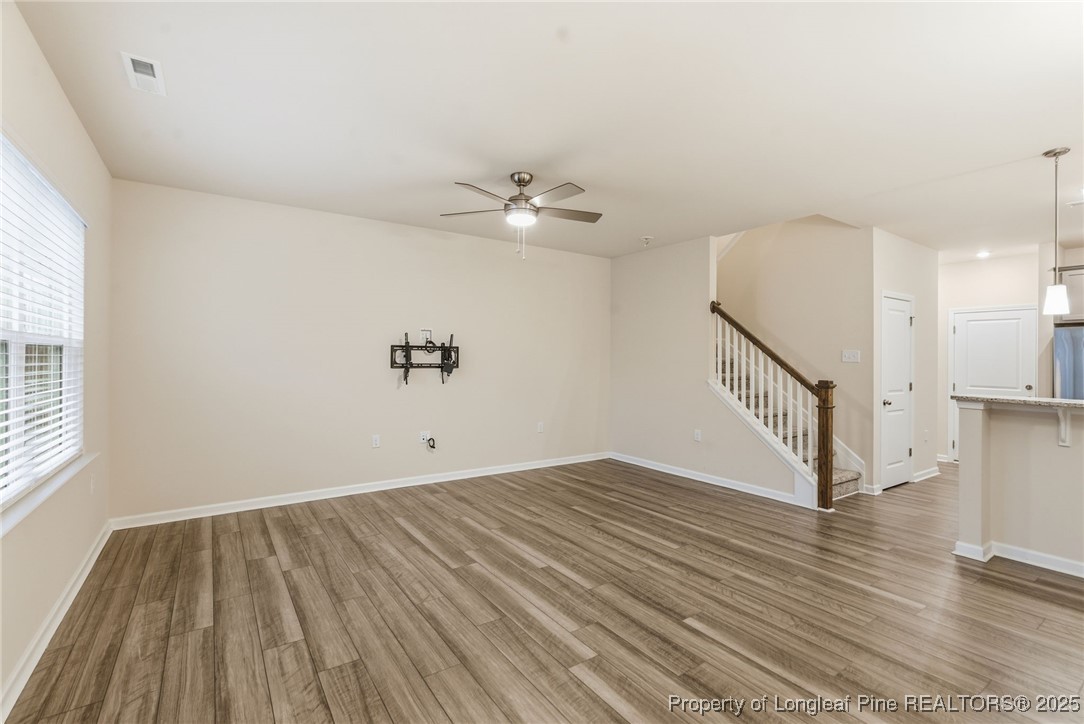 245 Ribbon Rail Street Fuquay-Varina, NC 27526 - Photo 8 of 43 wooden floor in an empty room with a window