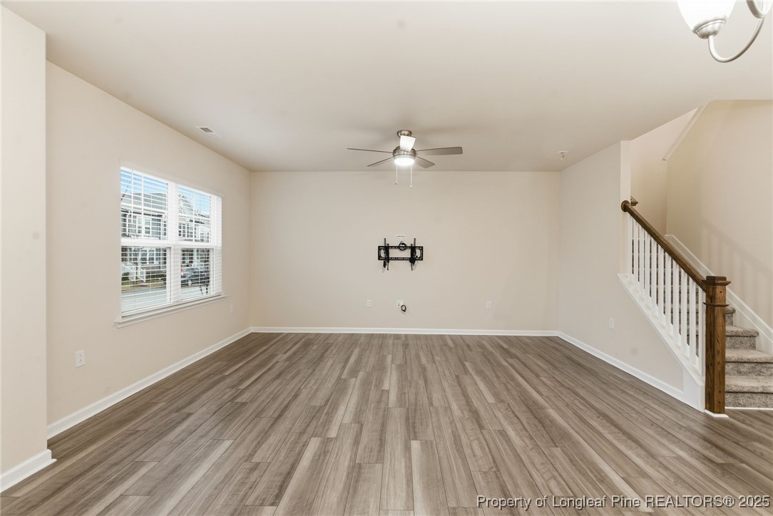 245 Ribbon Rail Street Fuquay-Varina, NC 27526 - Photo 9 of 43 wooden floor in an empty room with a window