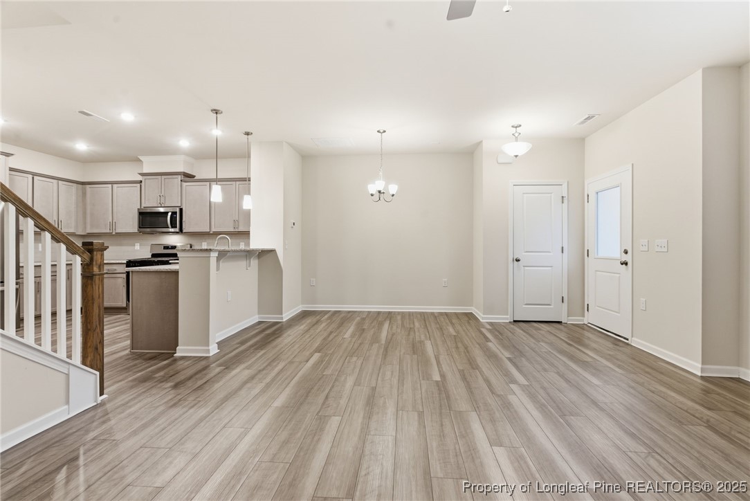 245 Ribbon Rail Street Fuquay-Varina, NC 27526 - Photo 10 of 43 a view of a kitchen with wooden floor