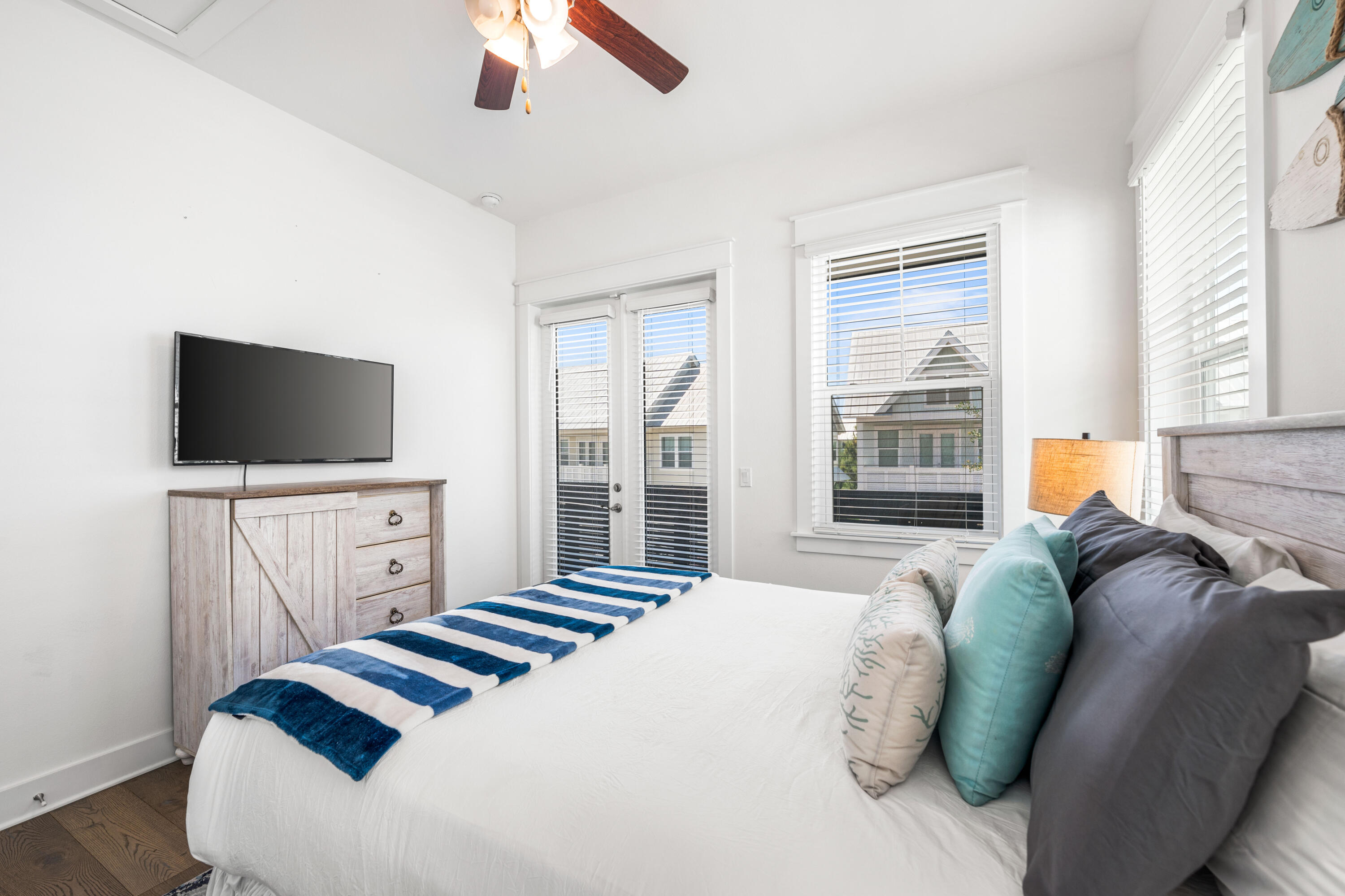 289 Milestone Dr Inlet Beach, Unit C Inlet Beach, FL 32461 - Photo 23 of 59 a bedroom with a bed and a flat screen tv