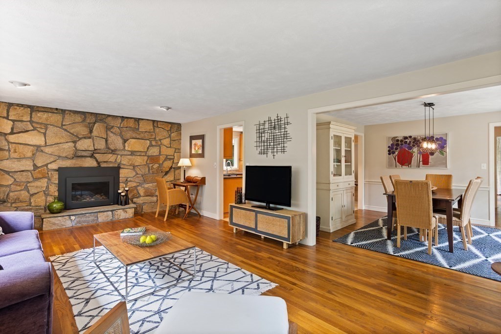 86 Pine Hill Road Boxborough, MA 01719 - Photo 12 of 42 a living room with furniture a flat screen tv and a fireplace