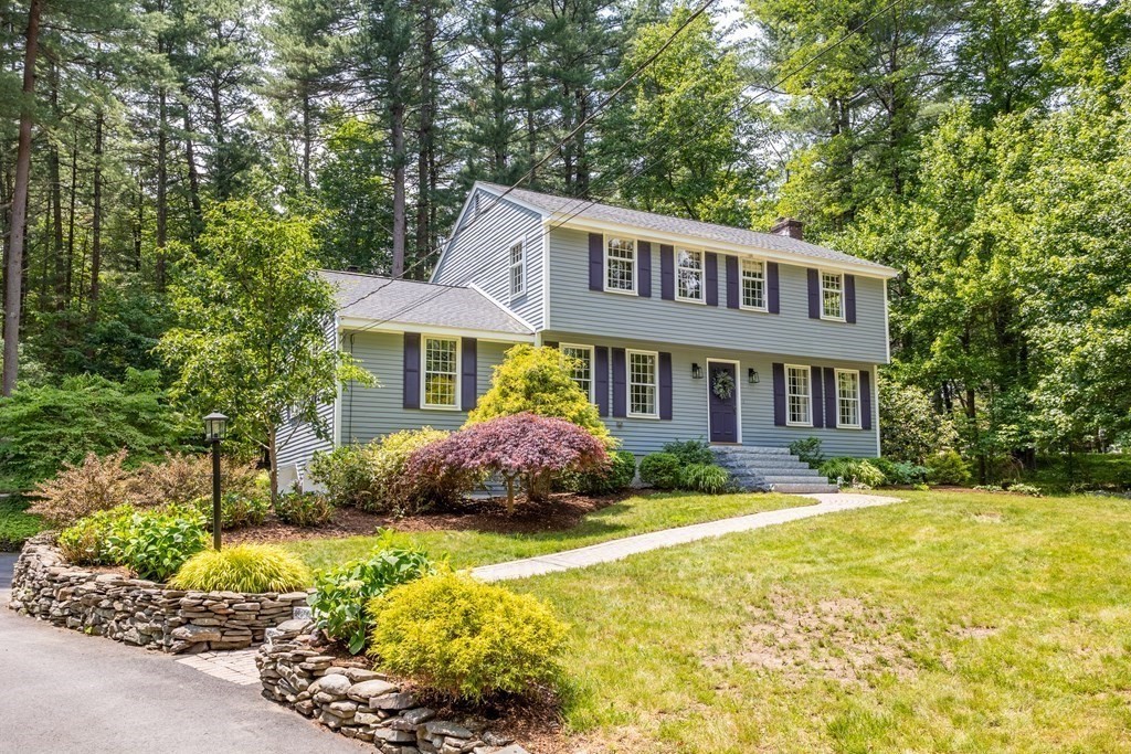 86 Pine Hill Road Boxborough, MA 01719 - Photo 29 of 42 a front view of a house with a yard and garage