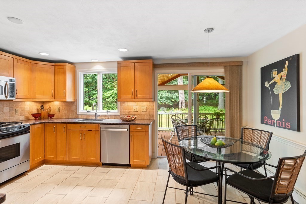 86 Pine Hill Road Boxborough, MA 01719 - Photo 3 of 42 a kitchen with stainless steel appliances granite countertop a stove top oven a sink dishwasher and wooden cabinets