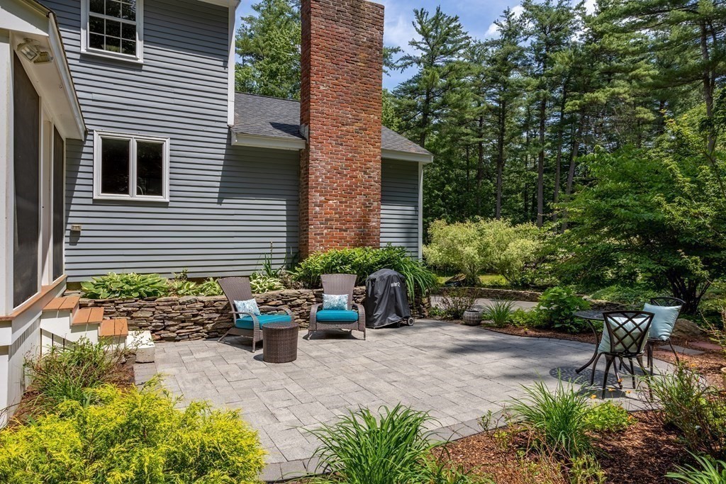 86 Pine Hill Road Boxborough, MA 01719 - Photo 35 of 42 a backyard of a house with a large tree and table and chairs