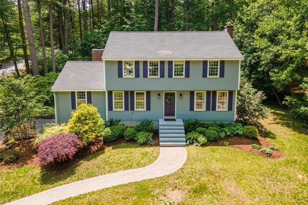 86 Pine Hill Road Boxborough, MA 01719 - Photo 36 of 42 a front view of a house with a yard and trees