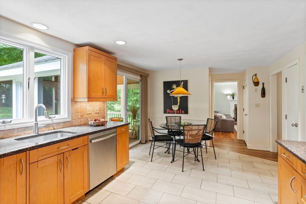 86 Pine Hill Road Boxborough, MA 01719 - Photo 5 of 42 a dining hall with stainless steel appliances granite countertop a stove a sink a dining table and chairs