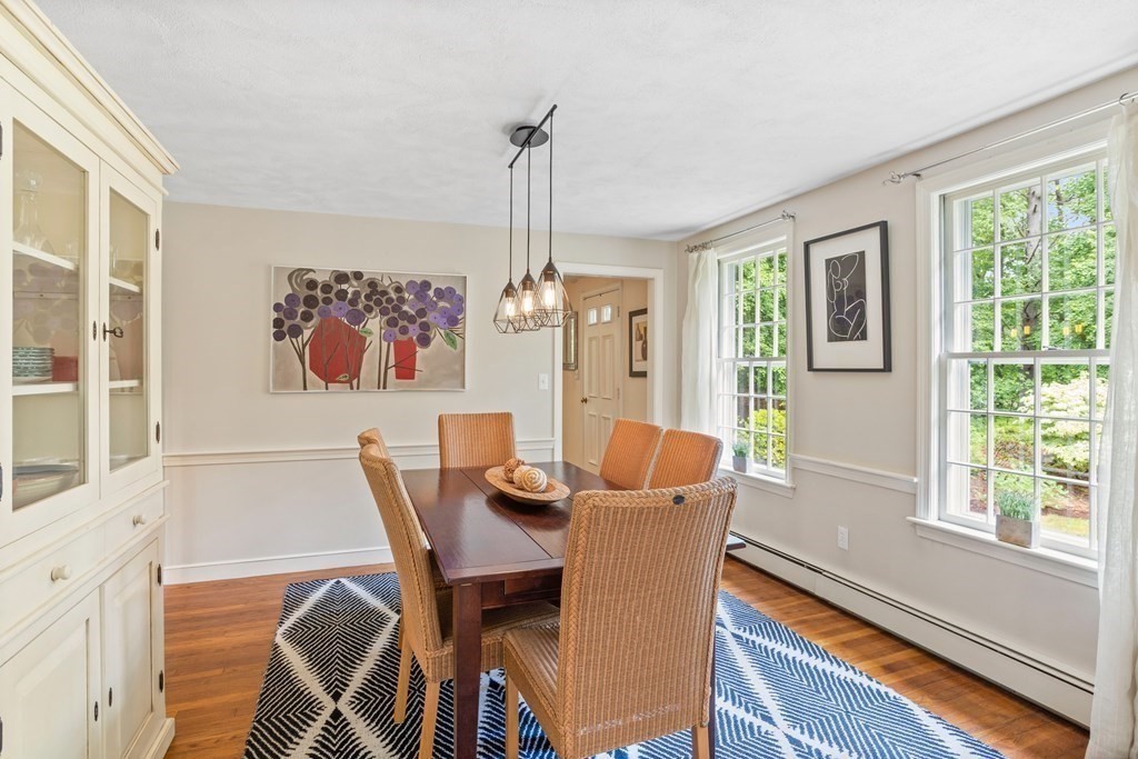 86 Pine Hill Road Boxborough, MA 01719 - Photo 8 of 42 a dining room with furniture a chandelier and wooden floor