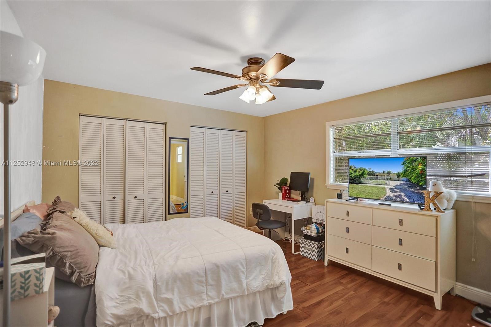 5930 Southwest 47th Street Miami, FL 33155 - Photo 13 of 43 a bedroom with a bed and a desk