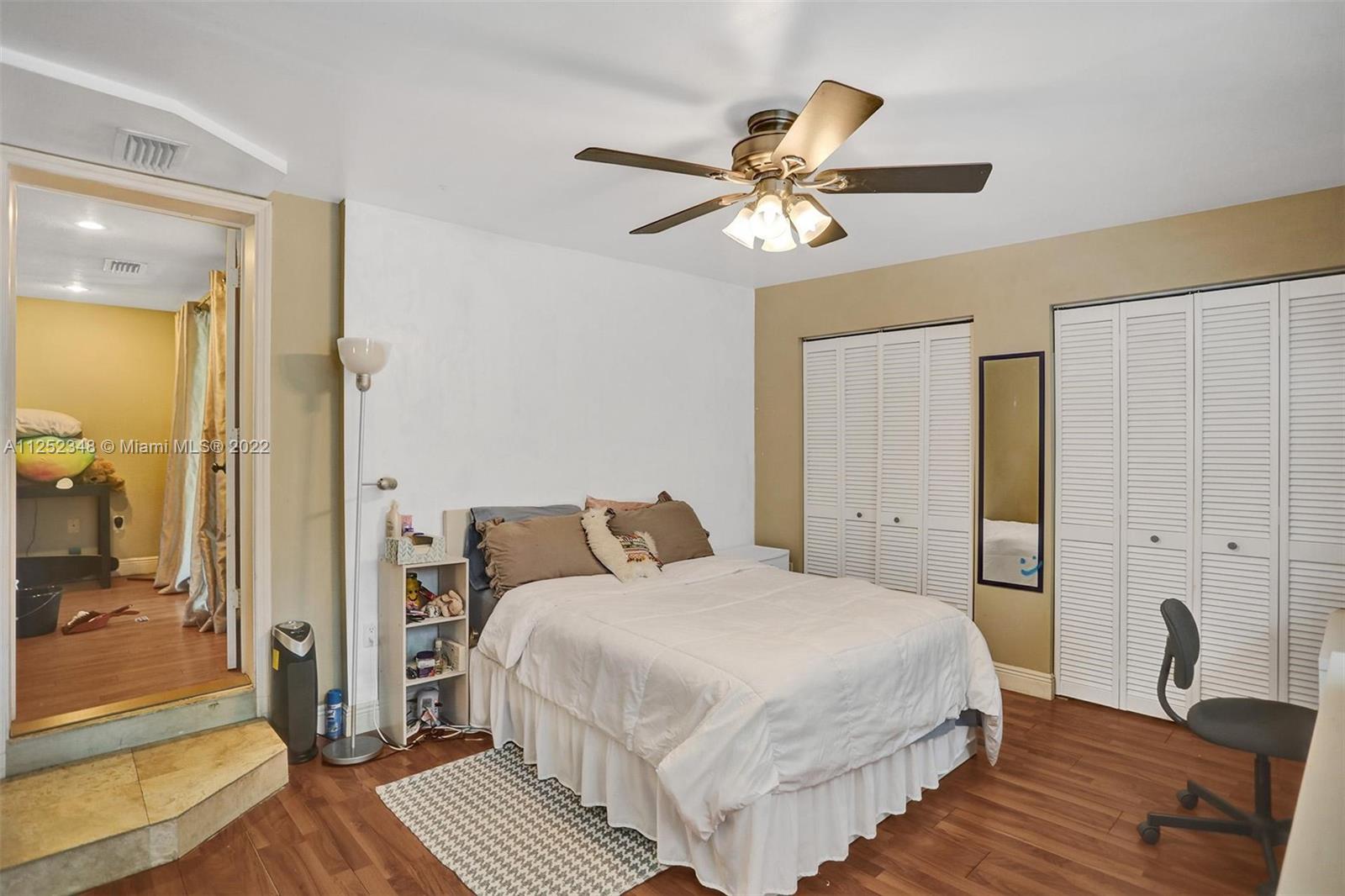 5930 Southwest 47th Street Miami, FL 33155 - Photo 14 of 43 a bedroom with a bed and a chandelier