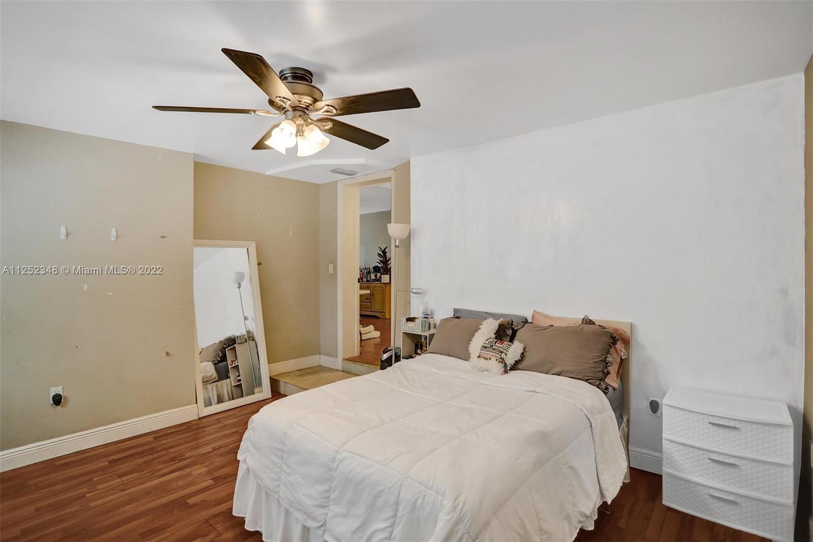 5930 Southwest 47th Street Miami, FL 33155 - Photo 16 of 43 a bedroom with a bed and a ceiling fan