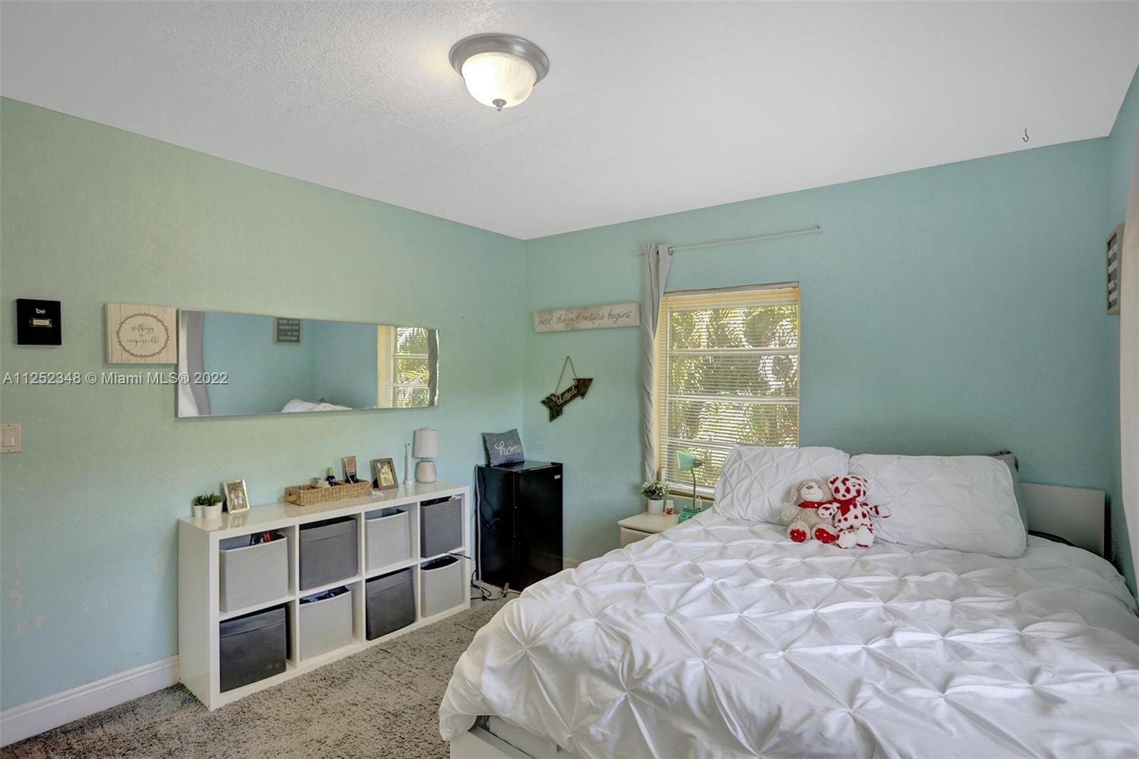 5930 Southwest 47th Street Miami, FL 33155 - Photo 19 of 43 a bedroom with a bed and a window