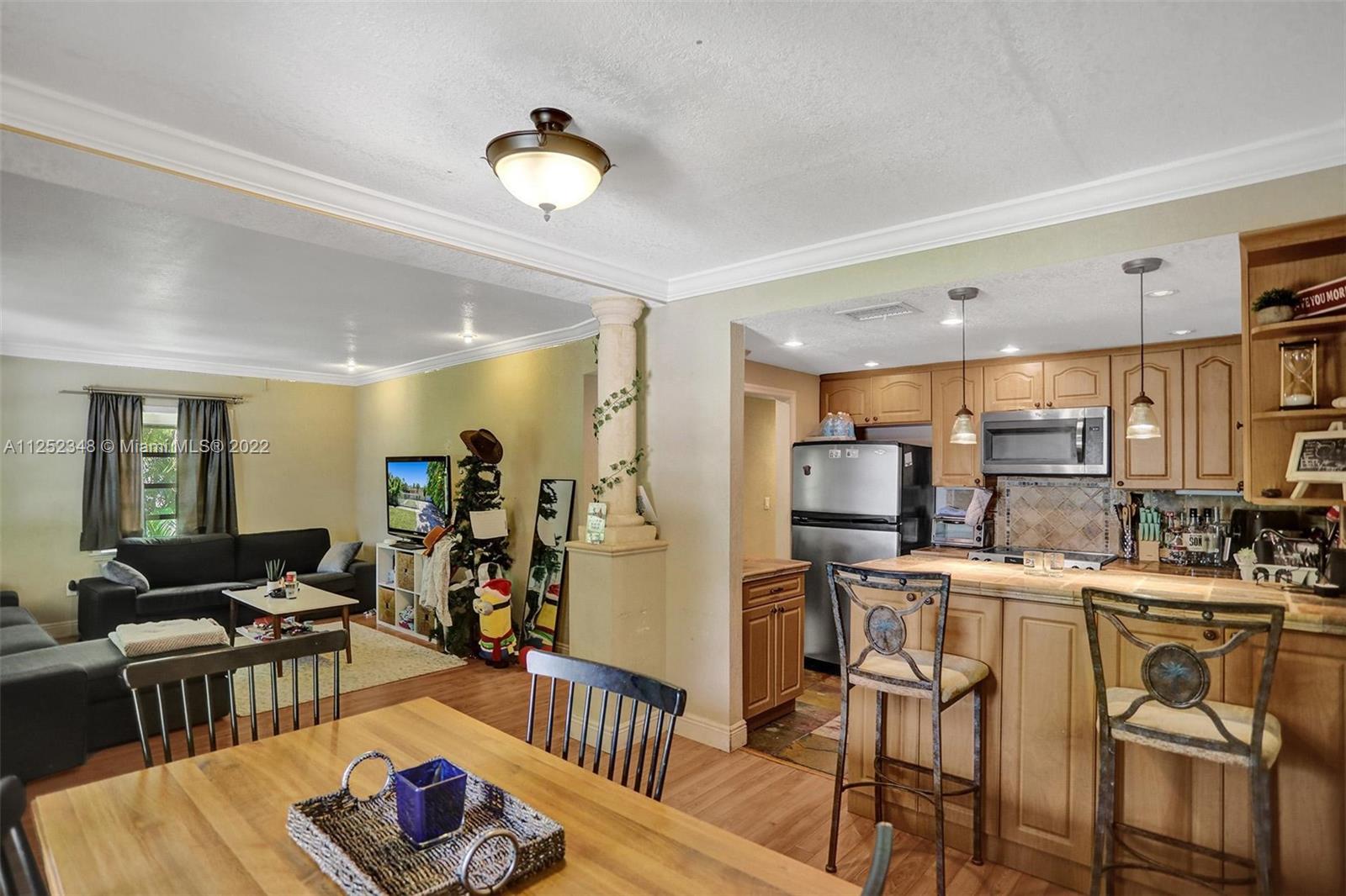5930 Southwest 47th Street Miami, FL 33155 - Photo 24 of 43 a living room with furniture kitchen view and a table