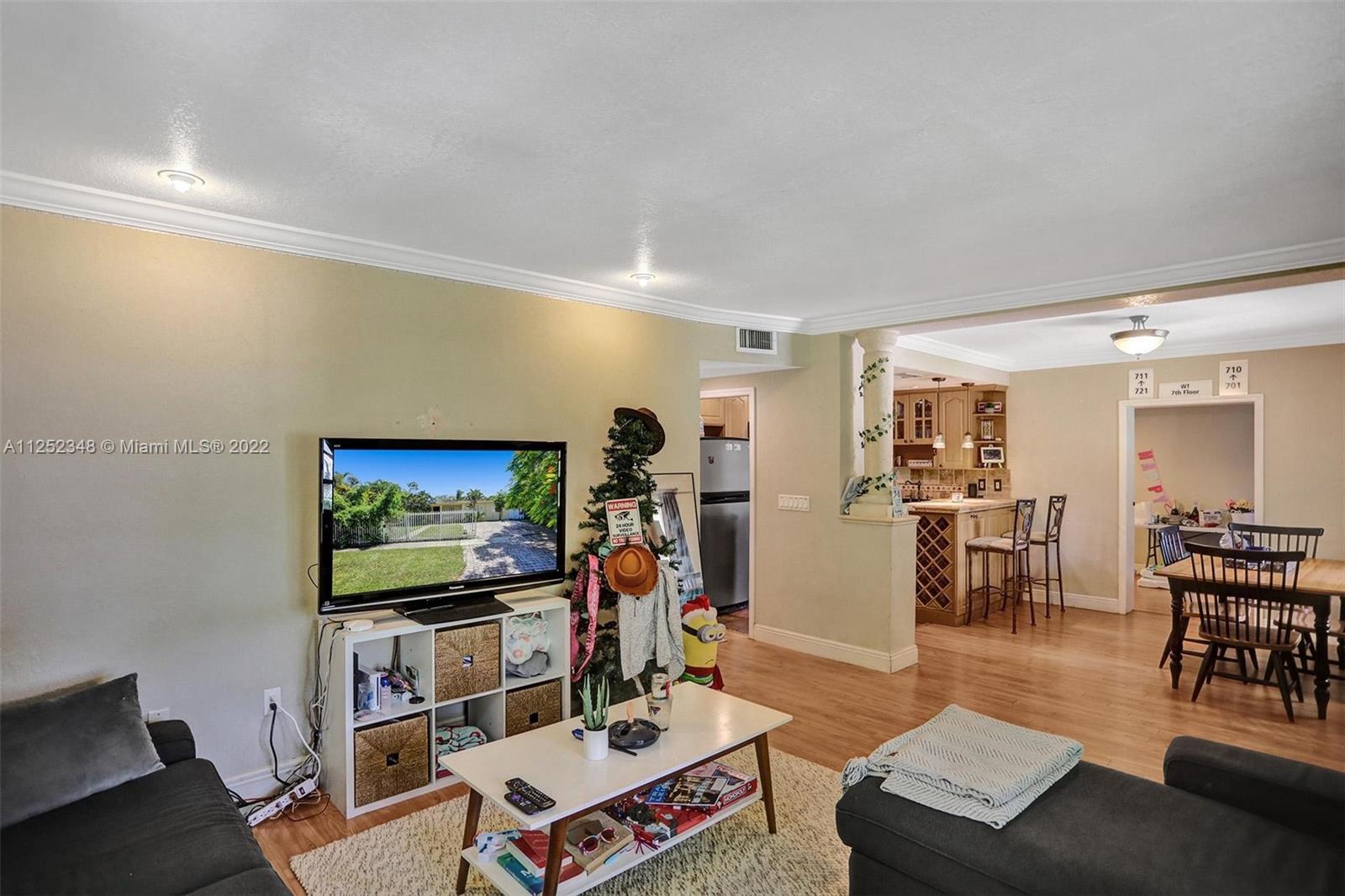 5930 Southwest 47th Street Miami, FL 33155 - Photo 29 of 43 a living room with furniture and a flat screen tv