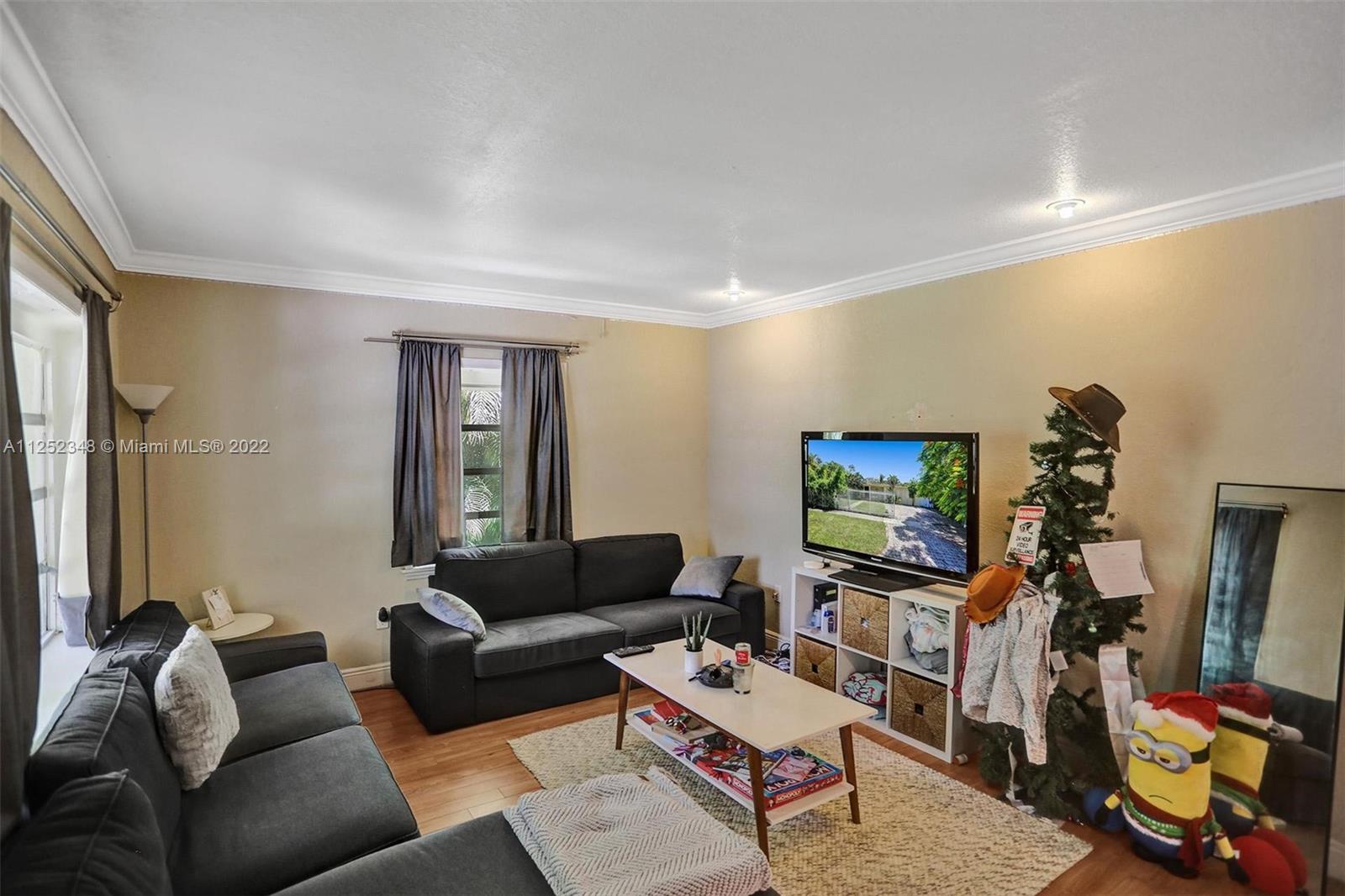 5930 Southwest 47th Street Miami, FL 33155 - Photo 32 of 43 a living room with furniture and a flat screen tv