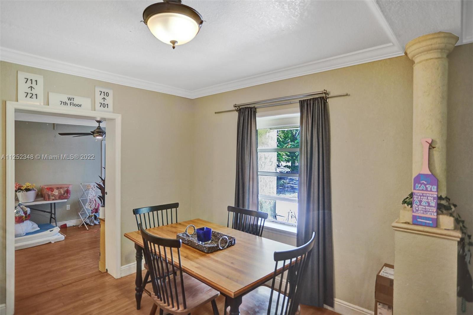 5930 Southwest 47th Street Miami, FL 33155 - Photo 34 of 43 a view of a dining room with furniture and wooden floor