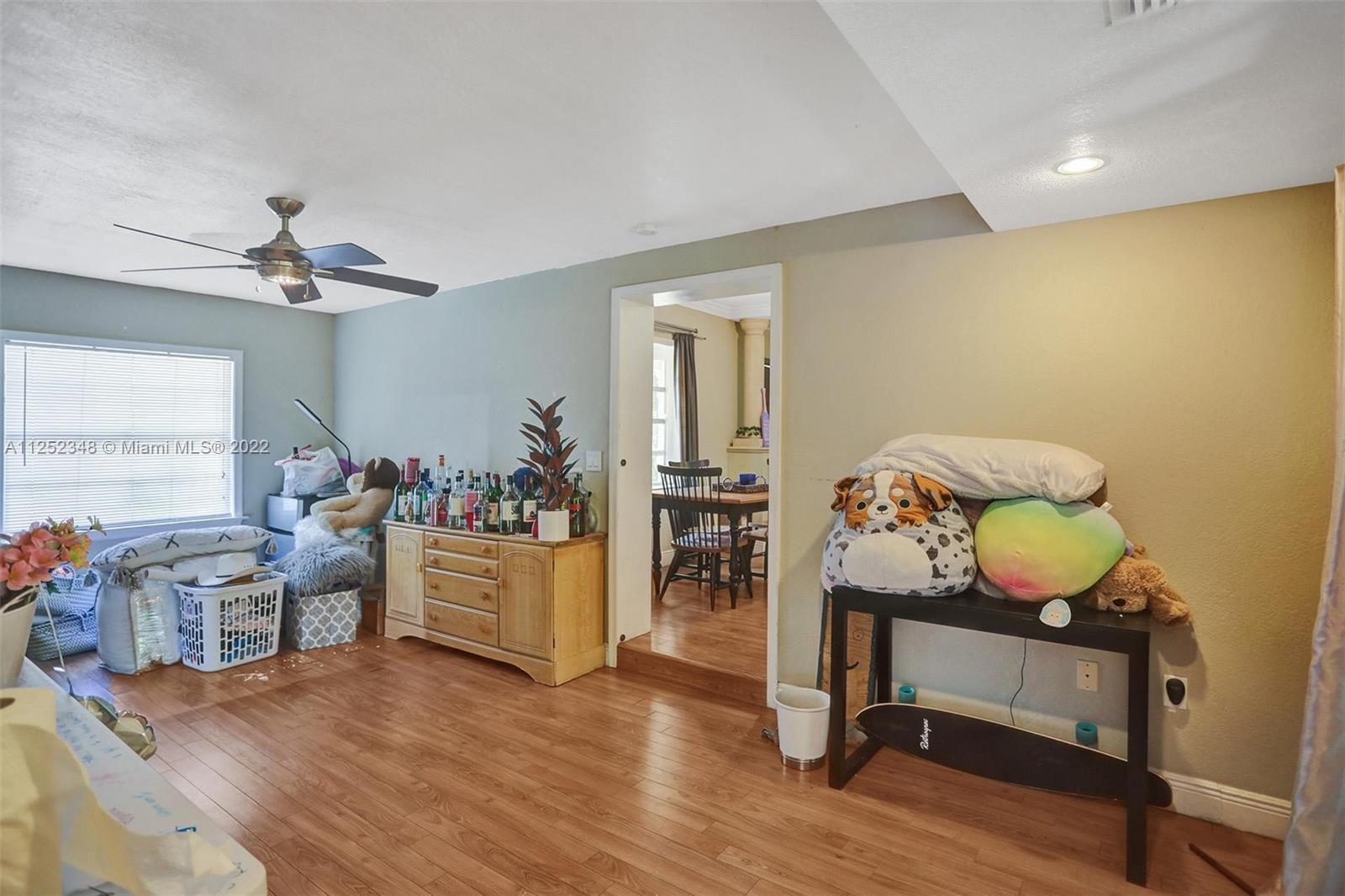 5930 Southwest 47th Street Miami, FL 33155 - Photo 37 of 43 a living room with furniture and a wooden floor