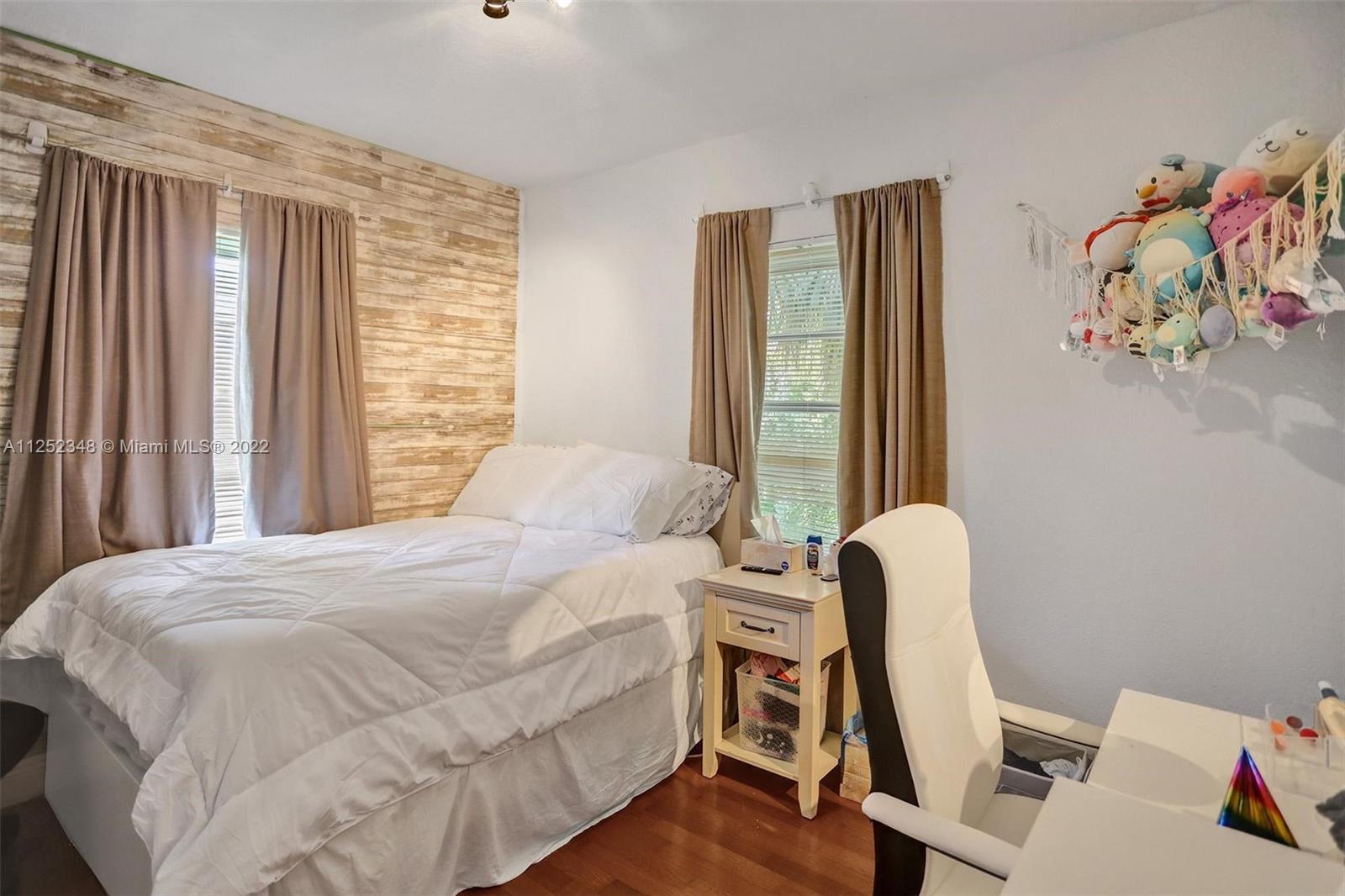 5930 Southwest 47th Street Miami, FL 33155 - Photo 41 of 43 a bedroom with a bed and a window