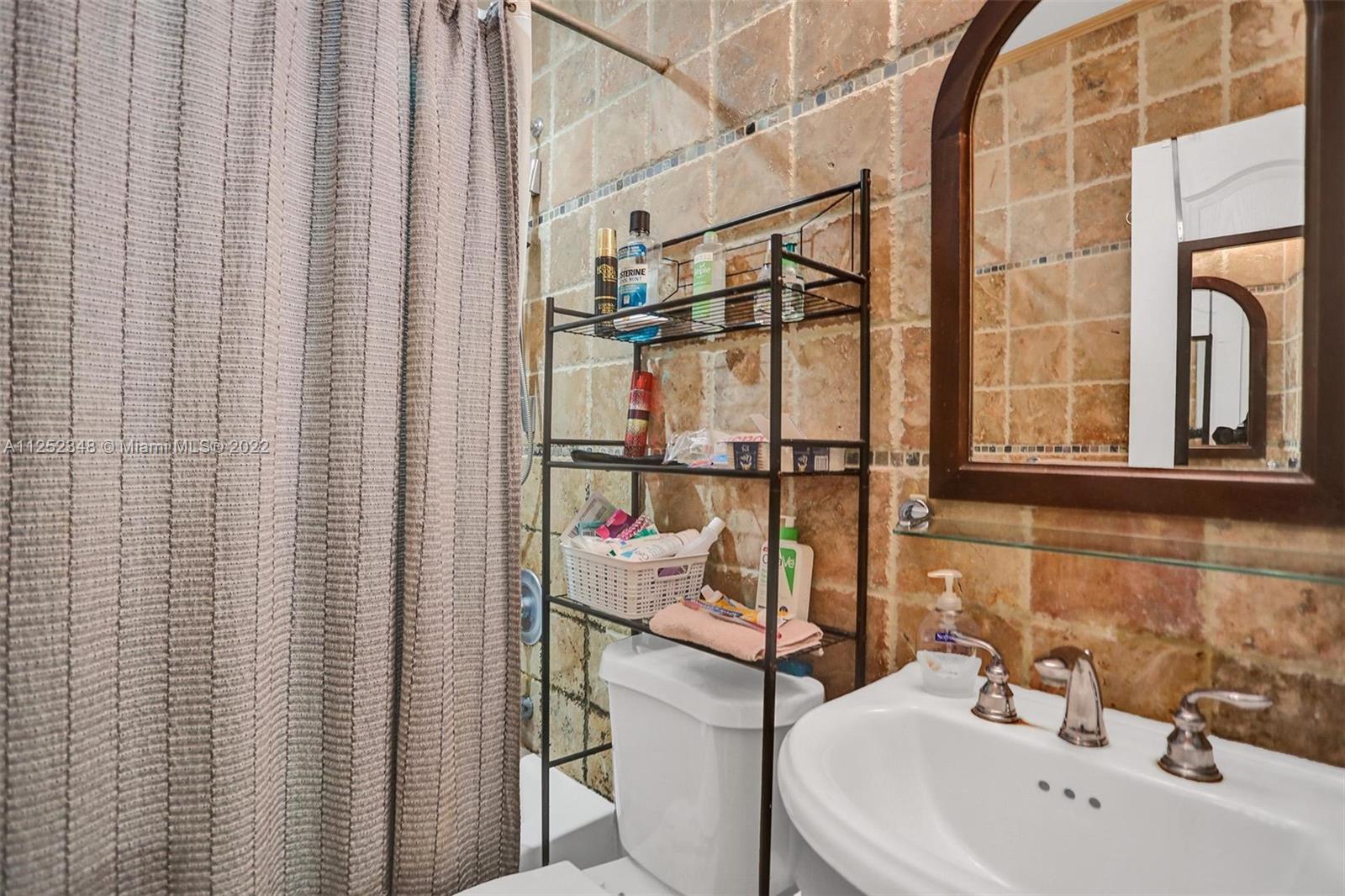 5930 Southwest 47th Street Miami, FL 33155 - Photo 42 of 43 a bathroom with a sink and mirror