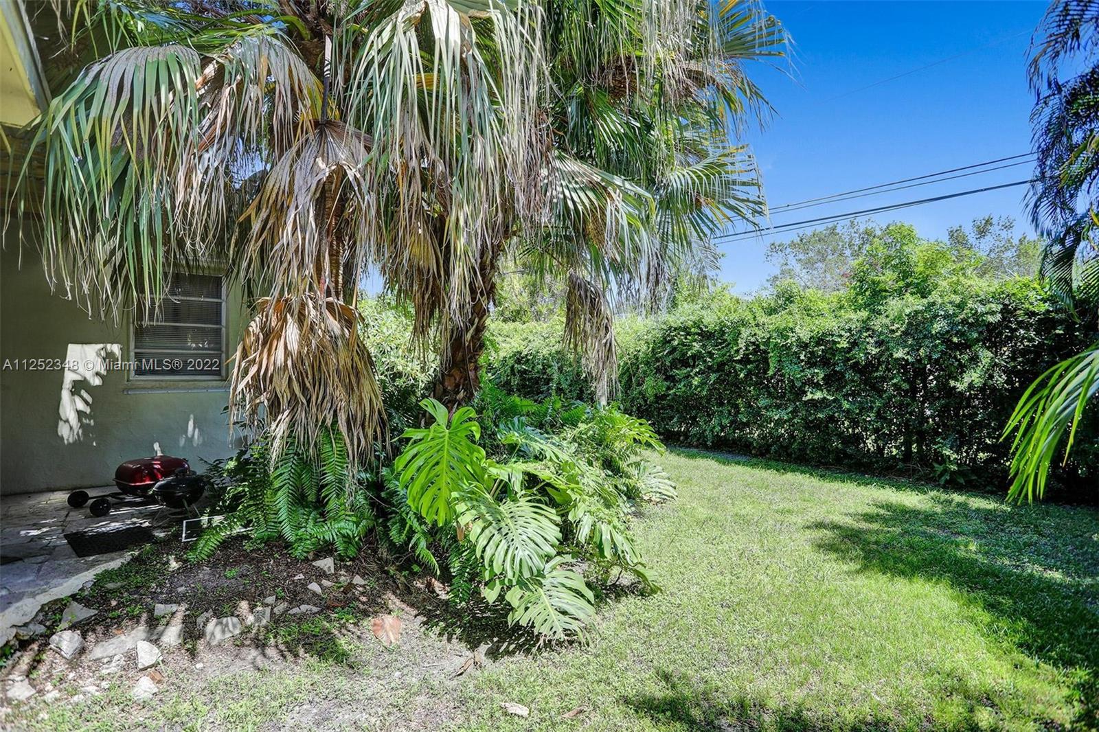 5930 Southwest 47th Street Miami, FL 33155 - Photo 8 of 43 a backyard of a house with a garden and outdoor seating