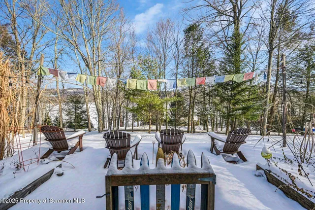a living room with furniture and large windows