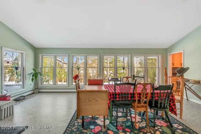 a view of a hallway with dining area