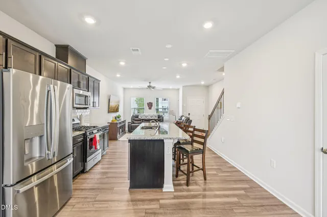 a view of a kitchen with furniture and a refrigerator