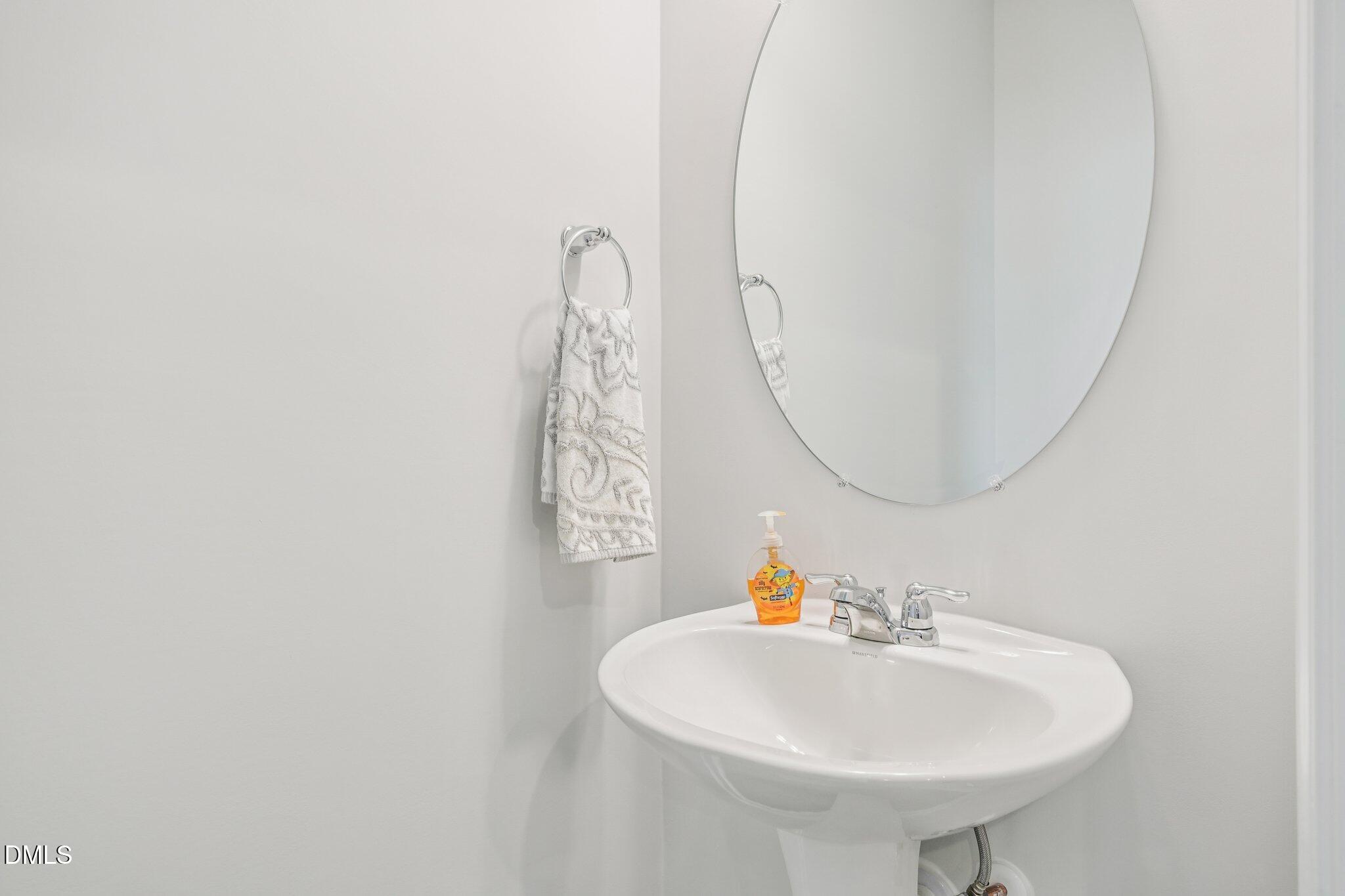 5348 Arkose Drive Raleigh, NC 27610 - Photo 12 of 21 a bathroom with a sink a mirror and a shower