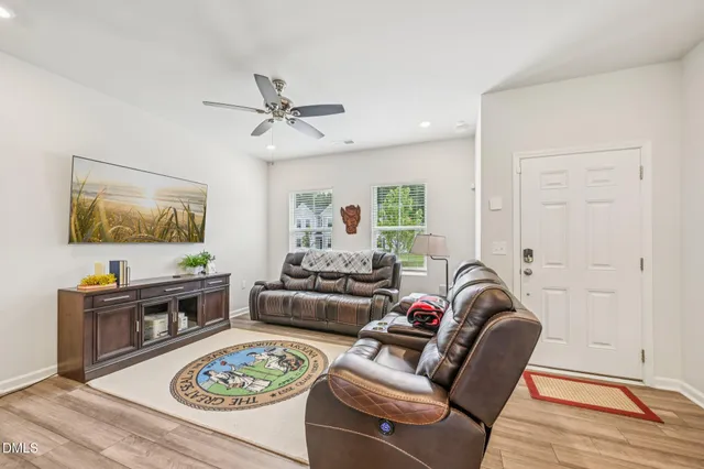 a living room with furniture a rug and a flat screen tv
