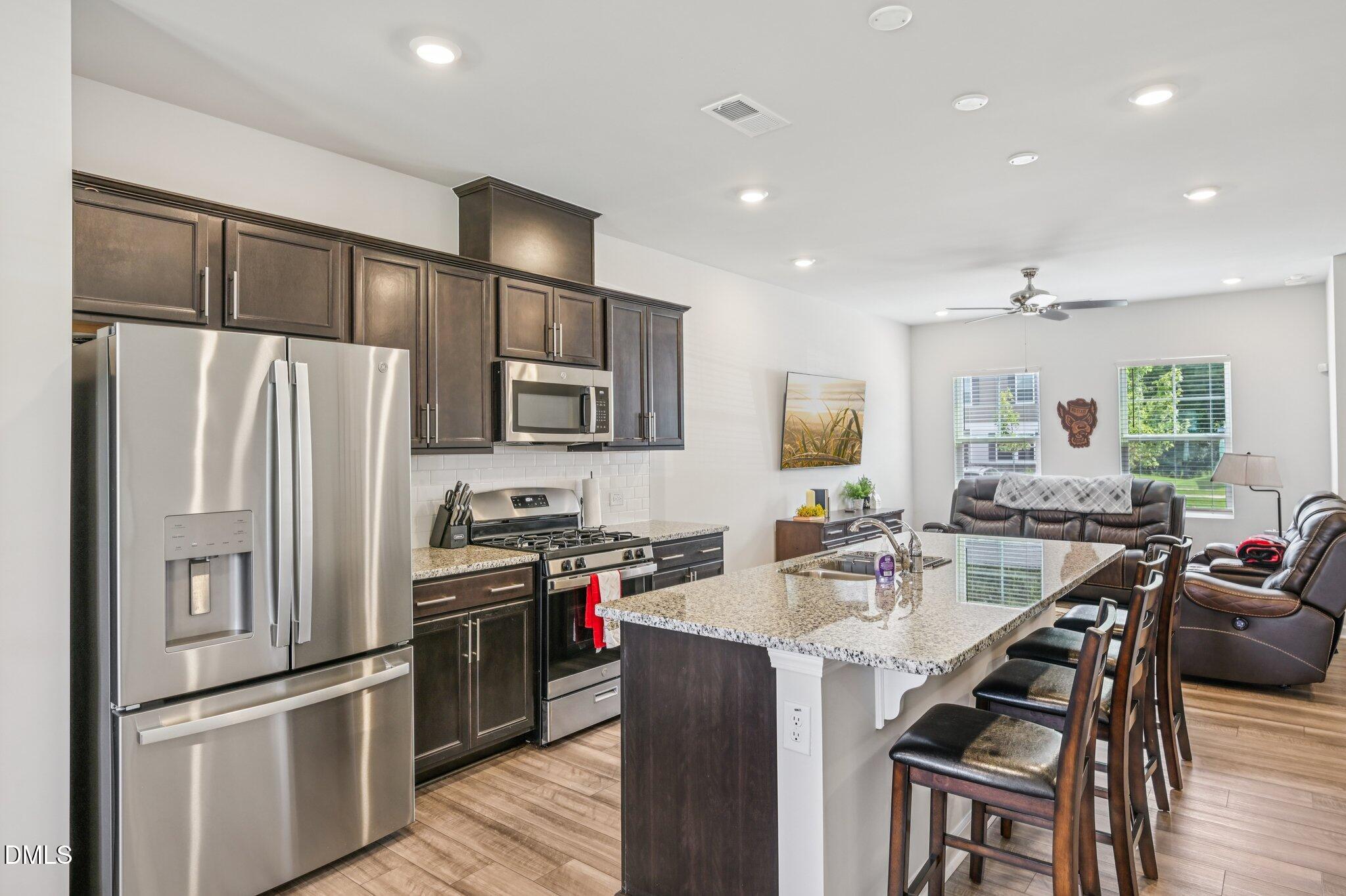 5348 Arkose Drive Raleigh, NC 27610 - Photo 10 of 21 a kitchen with refrigerator cabinets dining table and chairs