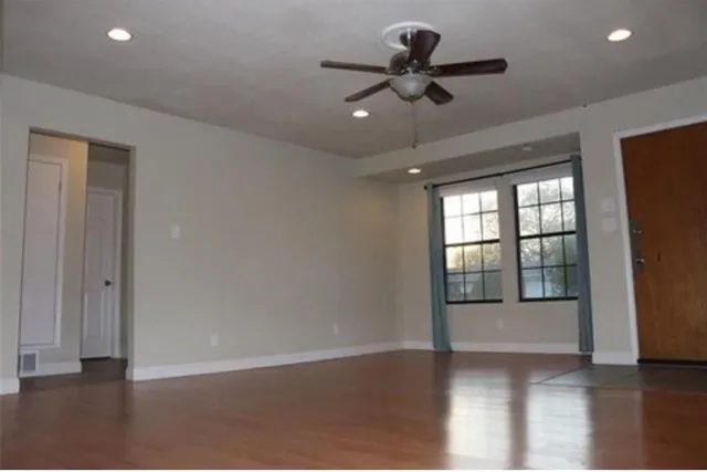 wooden floor in an empty room with a window