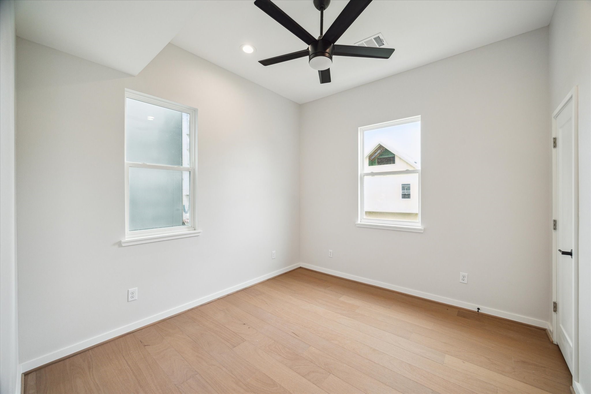 3908 Zina Way Houston, TX 77018 - Photo 27 of 33 an empty room with a window and a fan