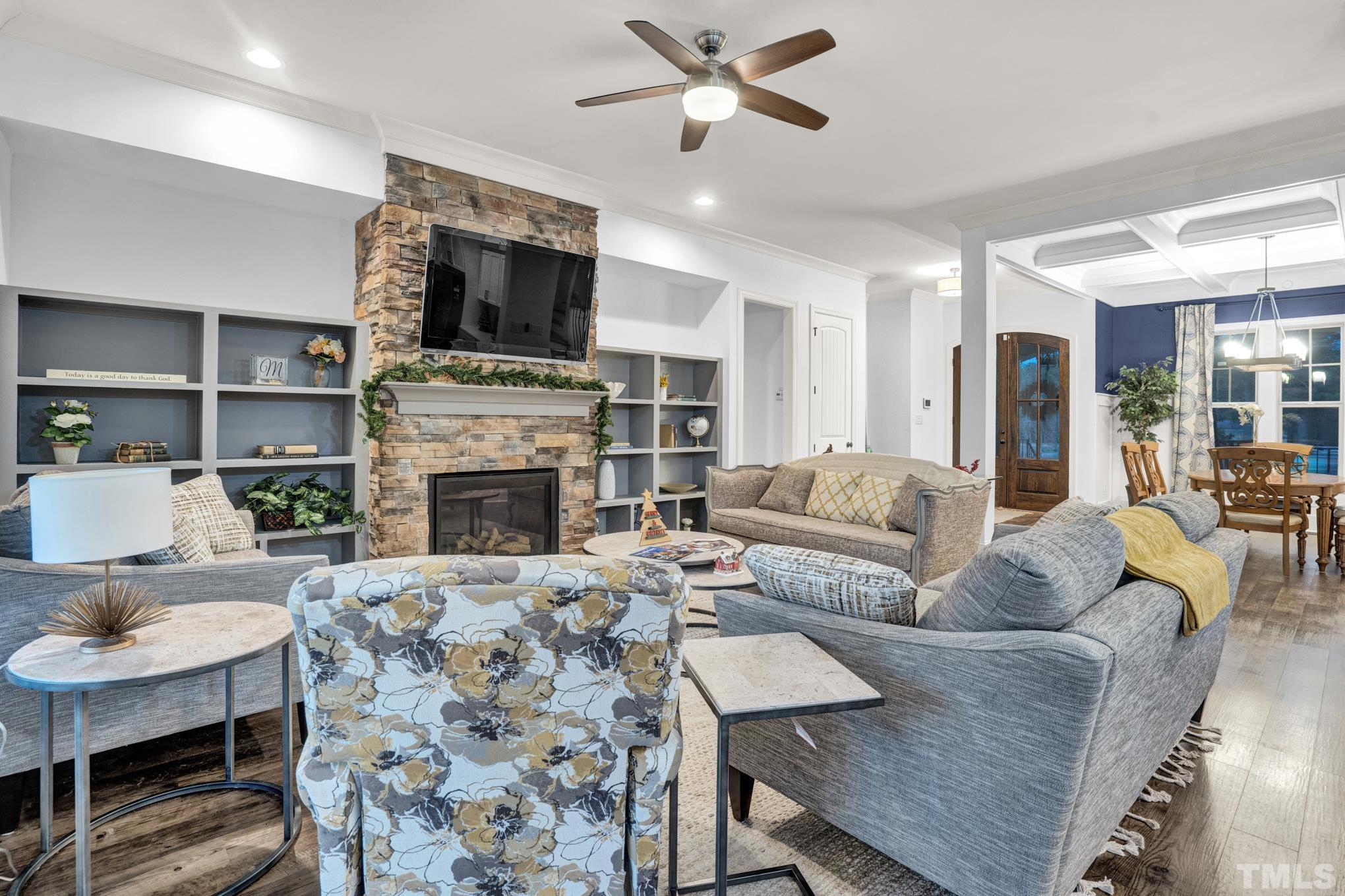 6752 Rock Quarry Road Garner, NC 27529 - Photo 8 of 36 a living room with furniture a fireplace and a flat screen tv