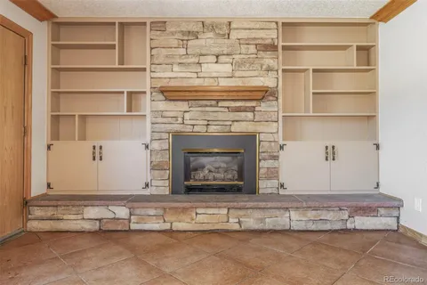 a view of fireplace with cabinets