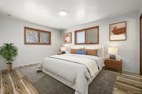 a spacious bedroom with a bed and a potted plant